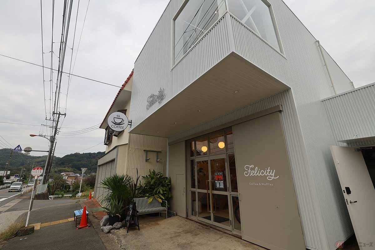 周囲を低い山々に囲まれ、長閑な雰囲気の生活道路沿いに建つ「Felicity Cafe」。目の前はバス停になっている
