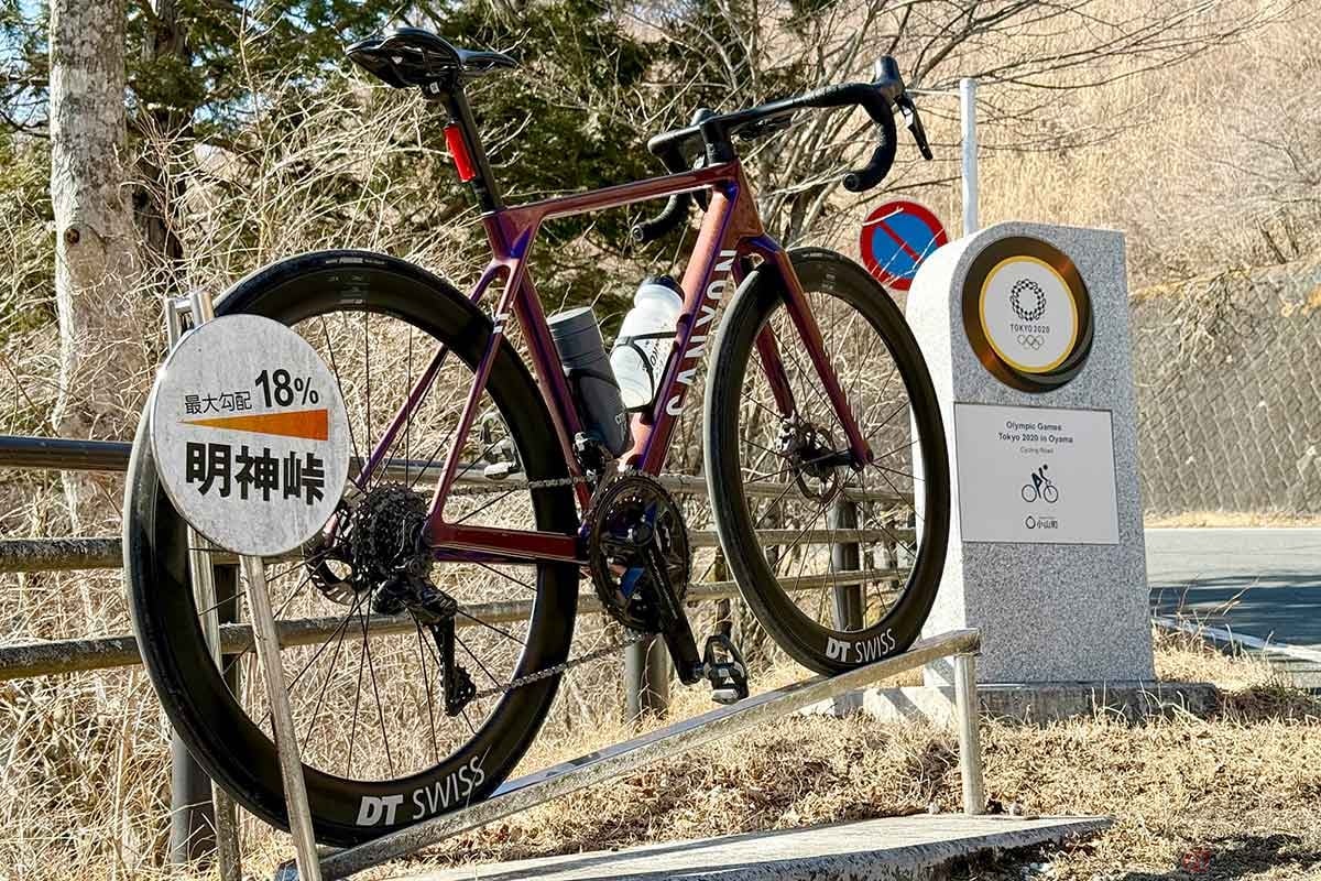「最大勾配18%」の表記が目をひく、明神峠のオリンピック記念碑。自転車を立てて写真撮影ができます