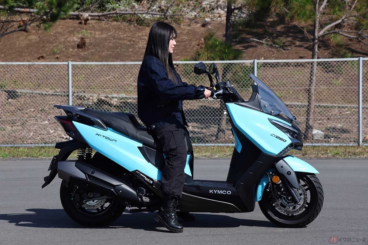 キムコのスクーターモデル「X-TOWN CT250」と筆者(高梨はづき)。身長(158cm)の筆者の場合、両足のつま先がしっかり接地します