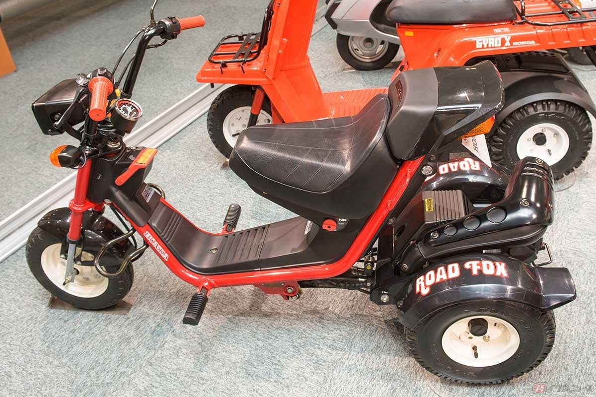 1984年に発売されたホンダの3輪スクーター第5弾「ロードフォックス」。赤いパイプフレームのフロント部分はライダーを乗せてスイングし、エンジンや2輪の駆動系はリア側に集中している